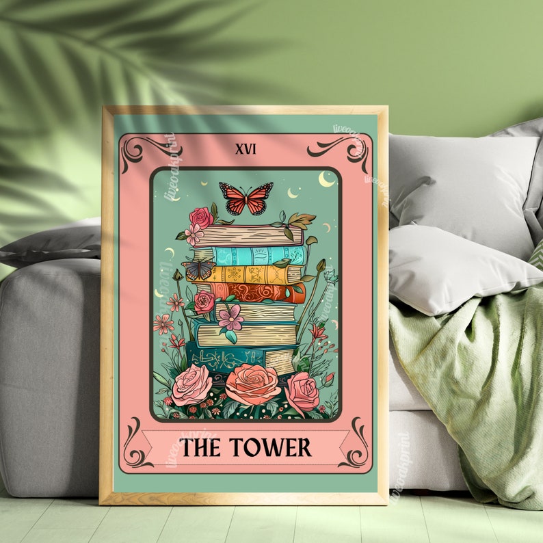 May include: A framed tarot card print featuring a stack of books with flowers and a butterfly. The card has a pink border and a teal background. The text "THE TOWER" is at the bottom, and "XVI" is at the top. The artwork has a vintage aesthetic.