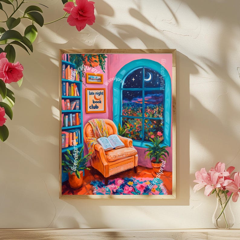 May include: A framed painting of a cozy living room with a bookshelf, a comfy armchair, and a window with a view of a moonlit night. The text "late night book club" is on a sign above the armchair.