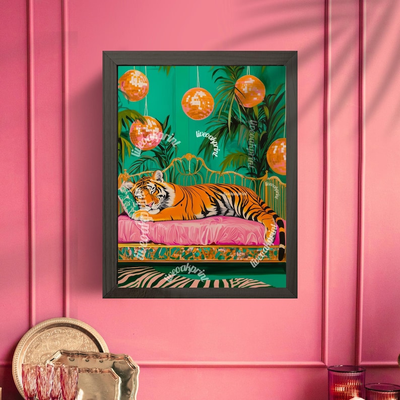 May include: A framed illustration of a tiger lying on a pink chaise longue with a green and gold patterned fabric. The tiger is surrounded by disco balls and lush green foliage. The background is a vibrant green.