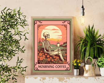 May include: Framed art print featuring a skeleton enjoying coffee in a field of flowers under a sunset. The artwork has a vintage style with a pink, orange, and green color palette. The text "MOURNING COFFEE" is at the bottom of the print.