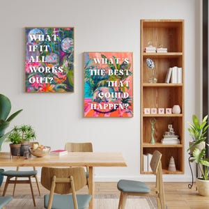 May include: Two colorful framed prints with motivational text. The first print has a pink, blue, and green background with the text "What if it all works out?" The second print has a pink, blue, and green background with the text "What's the best that could happen?"