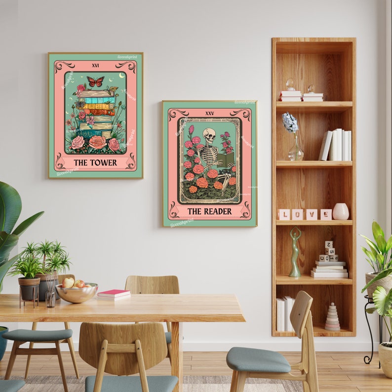 May include: Two framed tarot card prints. One features a stack of books, flowers, and a butterfly, labeled "The Tower." The other shows a skeleton reading amidst roses, labeled "The Reader."
