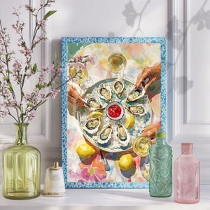 May include: A framed print shows a watercolour scene of oysters on ice, lemons, and hands reaching for the food. A small bowl of red sauce sits in the centre. The print has a blue border and is displayed with decorative vases.