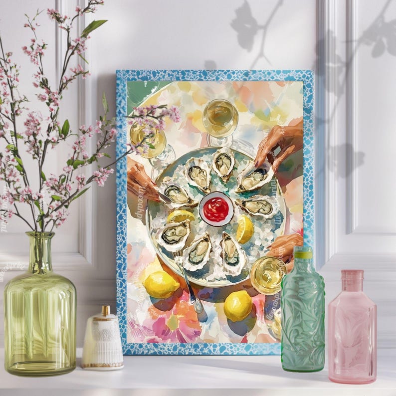 May include: A framed print shows a watercolour scene of oysters on ice, lemons, and hands reaching for the food. A small bowl of red sauce sits in the centre. The print has a blue border and is displayed with decorative vases.