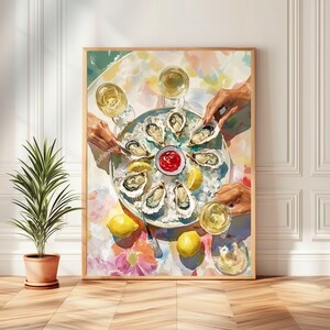 May include: A framed watercolour print shows a seafood platter with oysters, lemons, and a small bowl of red sauce. Two hands reach for the oysters, and two glasses of white wine are visible. The artwork has a colourful, floral background.