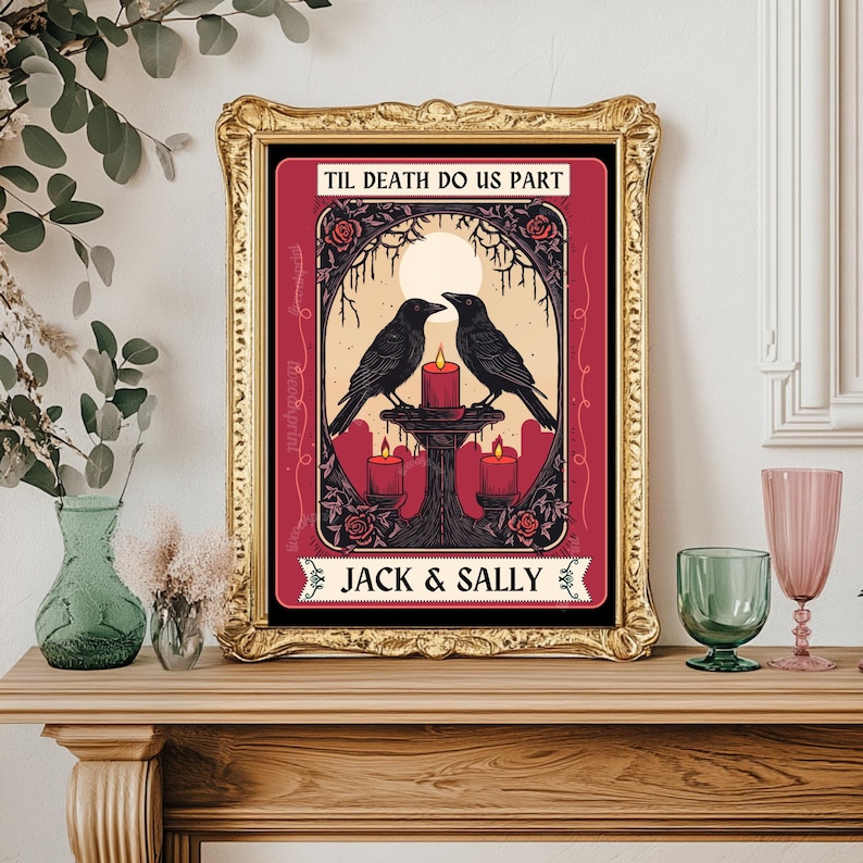 May include: Framed art print with a gold frame. The artwork features two black crows facing each other above a candlelit altar. The text "TIL DEATH DO US PART" and "JACK & SALLY" are displayed on the print. The background is burgundy with rose accents.