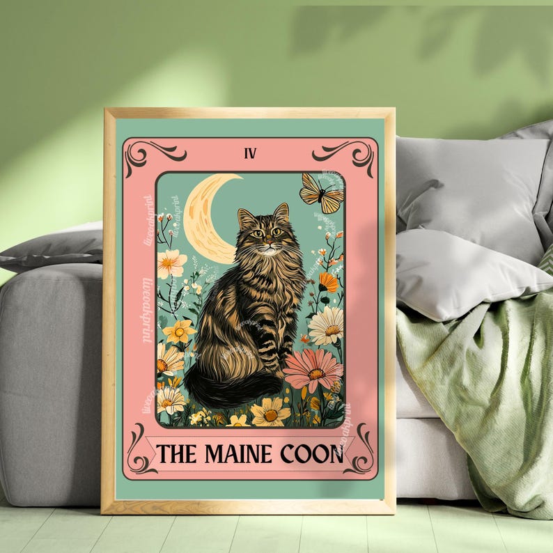 May include: A framed print featuring a Maine Coon cat tarot card design. The artwork showcases a brown tabby cat seated amidst flowers, a crescent moon, and a butterfly, with the text "THE MAINE COON" at the bottom.