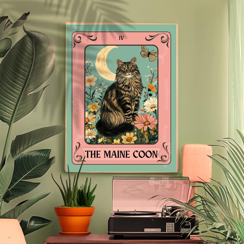 May include: A framed print featuring a Maine Coon cat in a tarot card design. The artwork showcases a brown and black tabby cat with a crescent moon, flowers, and a butterfly. The text "THE MAINE COON" is at the bottom.