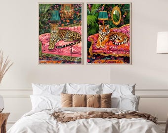 May include: Two vintage-style prints featuring a leopard and a tiger lounging on pink velvet couches with floral patterns. The prints have a jungle-themed background with lush greenery and ornate lamps.