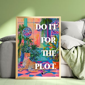 May include: A framed art print featuring a cheetah lying on a checkered floor, surrounded by plants and disco balls. The text "DO IT FOR THE PLOT" is displayed in white. The artwork has a vibrant color palette with pinks, blues, and greens.