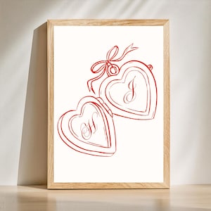 May include: A red line drawing of a heart-shaped locket with a bow on top. The locket is open and the inside of the locket is also heart-shaped. The locket has the letter "I" on one side and the letter "H" on the other side.