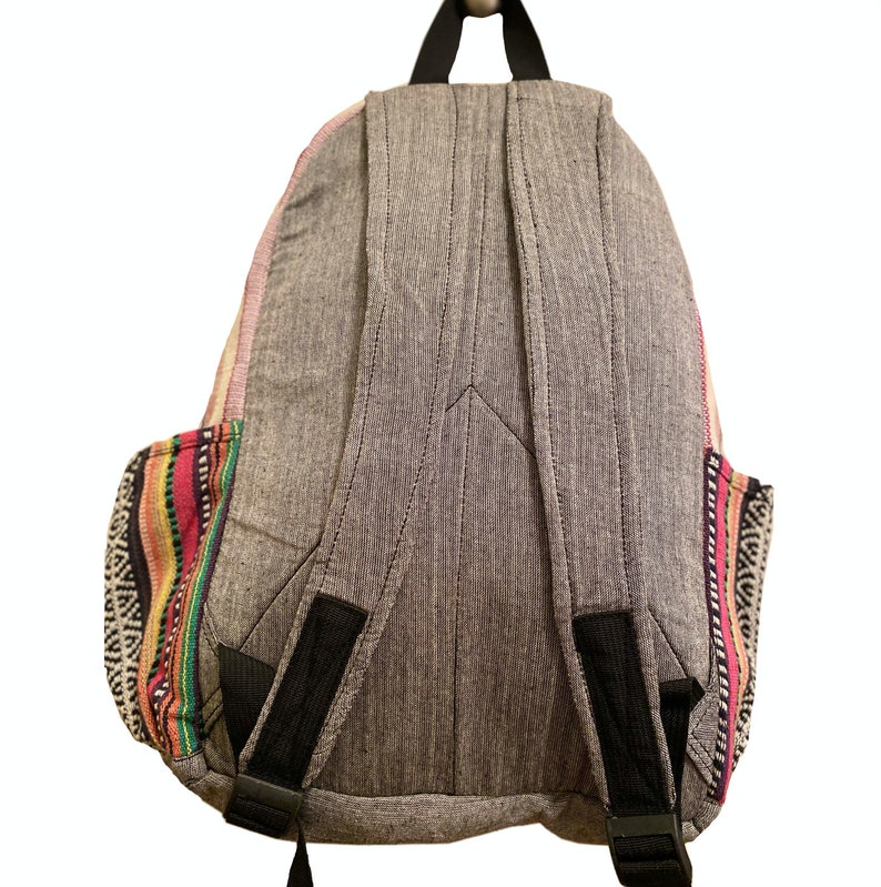 May include: A gray backpack with black straps and colorful woven trim. The backpack has a zippered closure and a large main compartment.