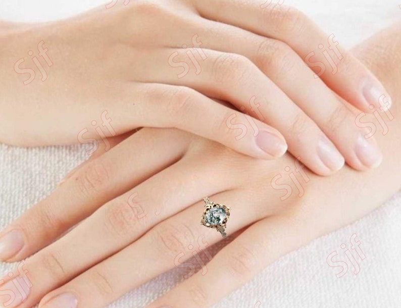 May include: A gold ring with a large, clear, faceted gemstone set in a floral design.