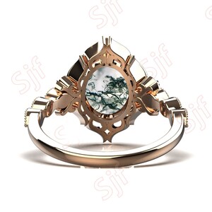 May include: A rose gold ring with a large, oval-shaped green and white agate gemstone set in a detailed, ornate filigree design.