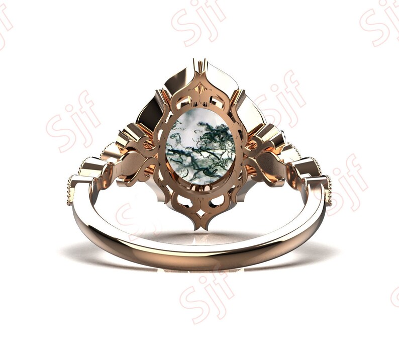 May include: A rose gold ring with a large, oval-shaped green and white agate gemstone set in a detailed, ornate filigree design.