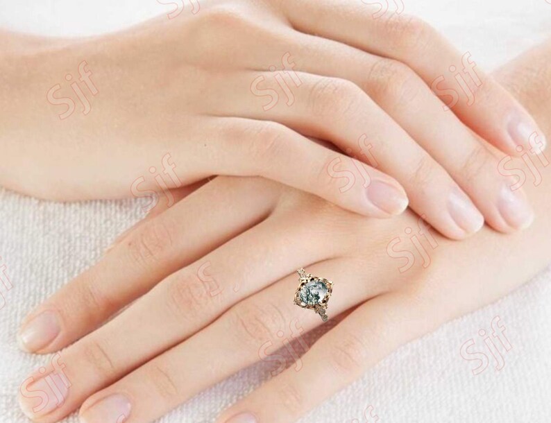 May include: A silver ring with a large, clear, faceted gemstone set in a delicate, ornate, gold-toned setting.