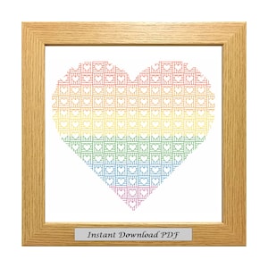 May include: A framed cross-stitch pattern of a rainbow heart with the text "Instant Download PDF" at the bottom.
