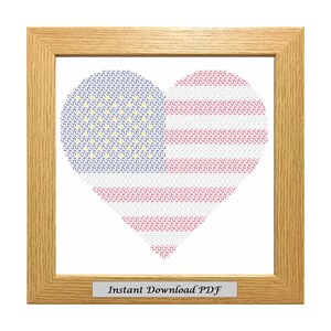 May include: A framed cross-stitch pattern of an American flag in the shape of a heart. The text "Instant Download PDF" is at the bottom of the frame.