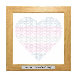 May include: A framed cross-stitch pattern of a heart made of smaller hearts in pink, blue, and white. The frame is light brown wood. The text "Instant Download PDF" is on a small plaque at the bottom of the frame.