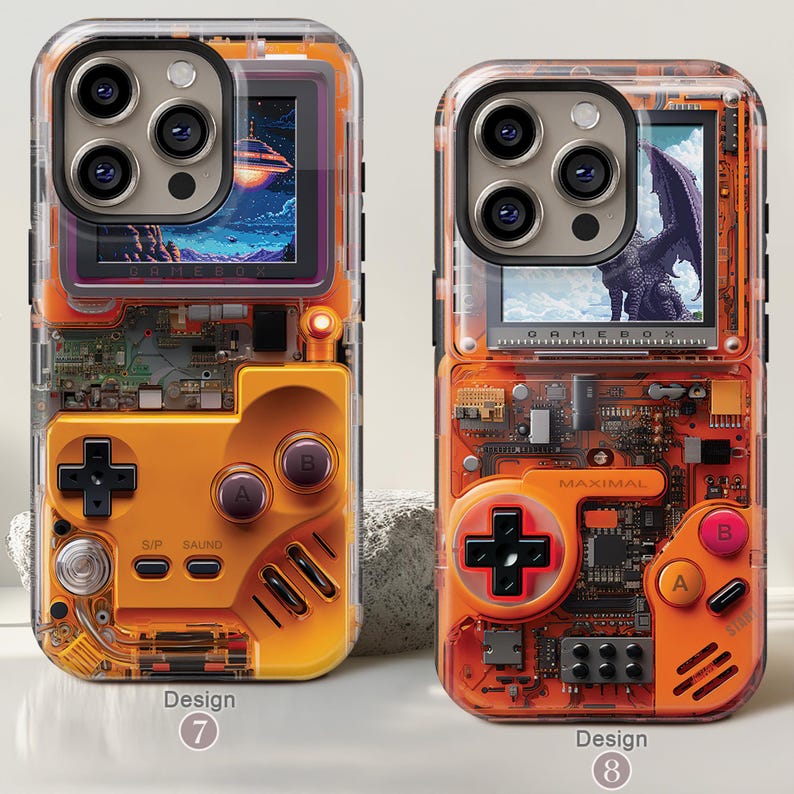 May include: Two clear phone cases with orange and black game console designs. One case features a space scene on the screen, the other a dragon. Each case has a directional pad, buttons, and the text "GAMEBOX" and "MAXIMAL".