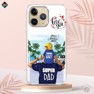 May include: A clear phone case with a colorful illustration of a father and son on a beach. The father is carrying the son on his shoulders. The son is wearing a yellow hat and a blue shirt that says "Super Baby". The father is wearing a blue shirt that says "Super Dad". The text "Love You" is written in black on the top of the case. The text "A Father is his Son's First Hero" is written in black on the bottom of the case.