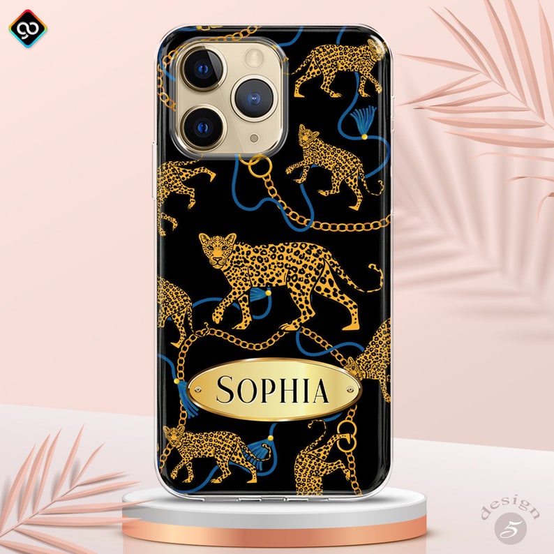 May include: A black phone case with a leopard print design and gold chains. The name "Sophia" is written in gold on a gold oval.