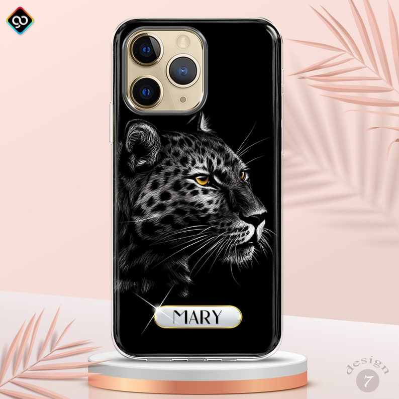 May include: Black phone case with a white and black leopard print design. The case has a gold trim and the name "MARY" is printed on the bottom in gold letters.