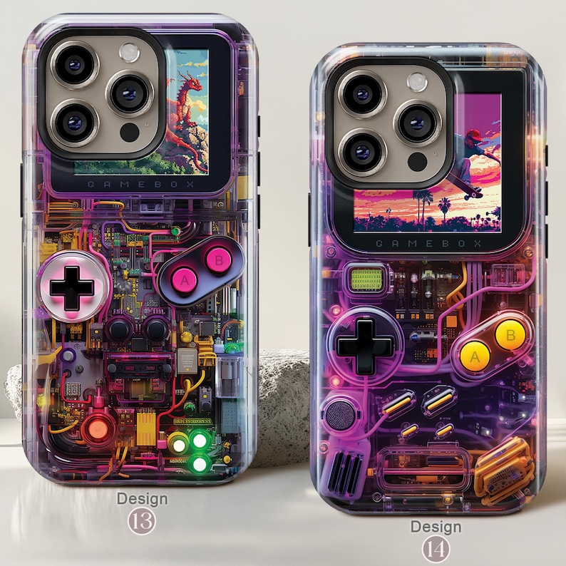 May include: Two clear phone cases with a retro video game design. Each case features a screen displaying a colorful image, with a controller layout of buttons and a D-pad. The cases are labeled "GAMEBOX" and have the design numbers 13 and 14.