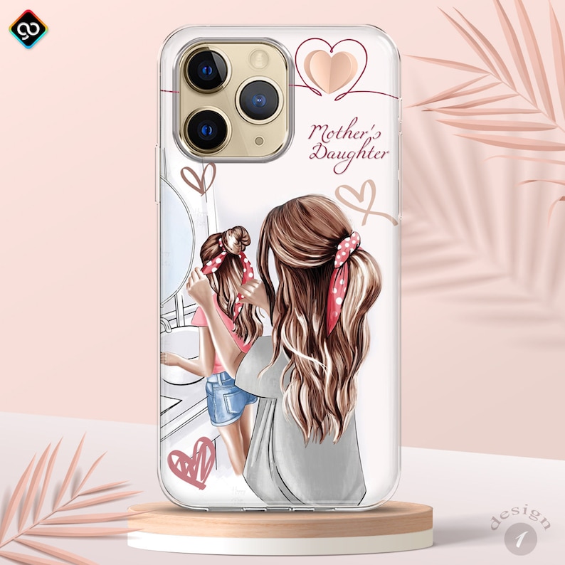 May include: A clear phone case with a white background and a design of two women with long brown hair. The women are wearing casual clothing and have red and white polka dot headbands. The text "Mother's Daughter" is written in pink on the case.