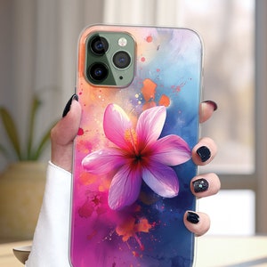 May include: A clear phone case with a pink flower design. The background is a watercolor-style design with blue, pink, and orange colors.