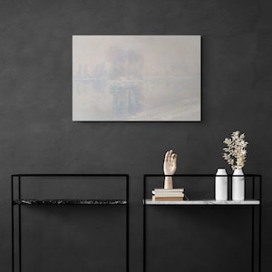 May include: A black and white painting of a foggy landscape with a river and trees reflected in the water. The painting is hanging on a dark gray wall above two black metal shelves with white marble tops. The shelves are decorated with a wooden hand sculpture, books, and two white ceramic vases with dried flowers.