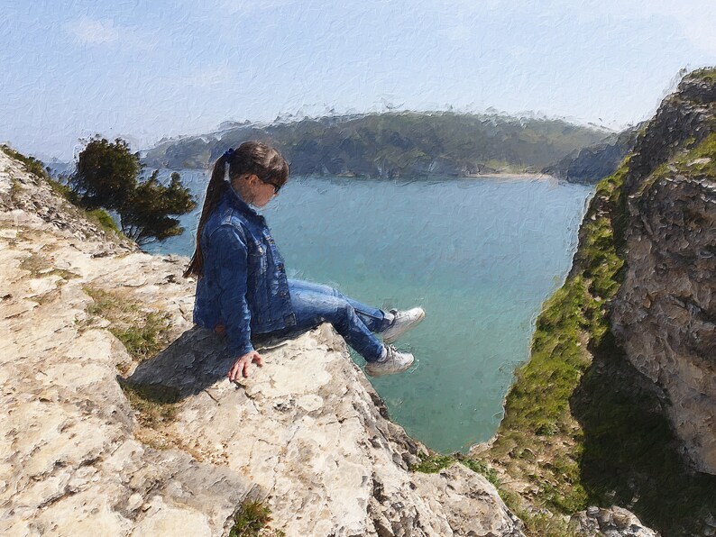 May include: A person wearing a blue denim jacket and jeans sits on a rocky cliff overlooking a calm, blue body of water. The scene is painted with an artistic, textured effect, suggesting a serene outdoor setting.