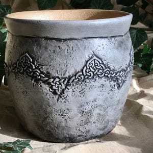 Ceramic pots with embossed Nordic knot ornaments