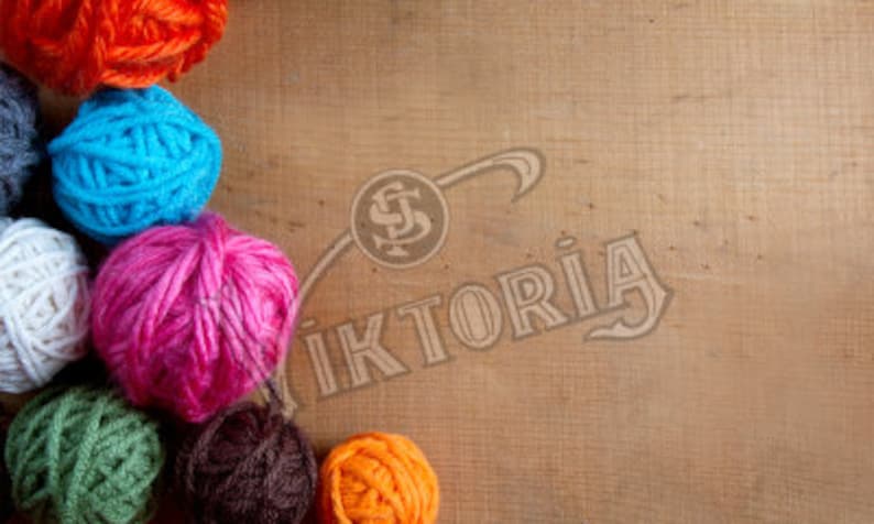 May include: A collection of colorful yarn balls in shades of orange, blue, pink, green, and white, arranged on a wooden surface. The image includes the text "Viktoria" in a stylized font.
