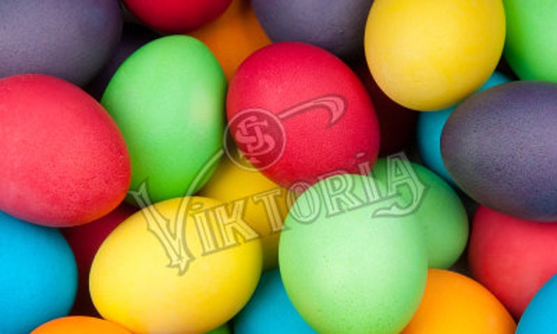 May include: A close-up of a collection of brightly colored Easter eggs. The eggs are dyed in various colors, including red, green, yellow, blue, and purple. The eggs are arranged closely together, filling the frame.