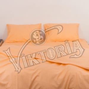 May include: Peach-colored bed linens set on a bed. The set includes a duvet cover and two pillowcases. A nightstand with a decorative sign that reads "THE BEST JOURNEY ALWAYS TAKES US HOME" is visible in the background.