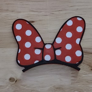 May include: Red and white polka dot bow with a black headband.