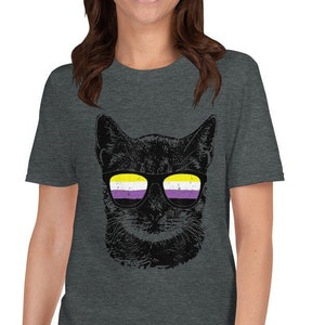 May include: A dark heather grey t-shirt featuring a black cat wearing sunglasses with the colors of the non-binary pride flag.