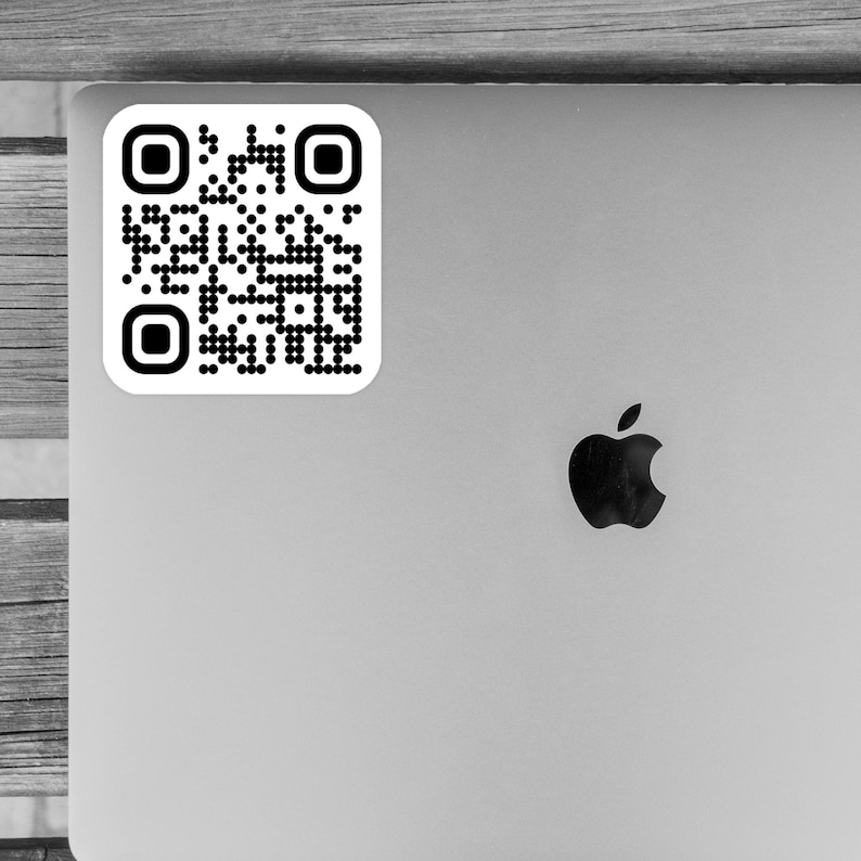May include: A black and white QR code sticker on a silver laptop.