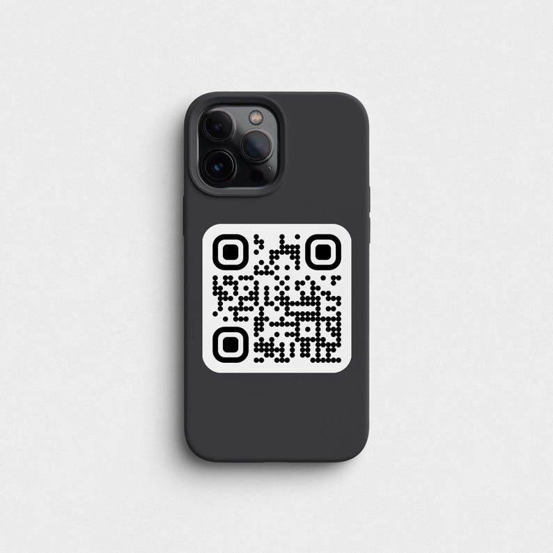 May include: A black phone case with a white QR code on the back. The phone case has a camera lens cutout.