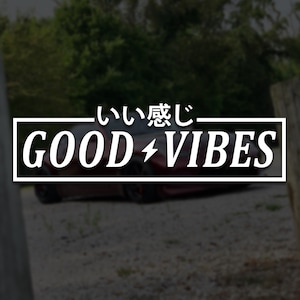 Puede incluir: Un coche rojo con una pegatina blanca que dice "いい感じ - GOOD ⚡️ VIBES" en una caja negra.