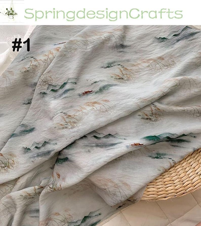 Peut inclure: Tissu blanc cass&eacute; avec un motif de paysage repr&eacute;sentant des montagnes, de l'eau et des bateaux. Le tissu a un aspect aquarelle avec des tons verts, bruns et gris. Le texte "SpringdesignCrafts" et "#1" sont visibles.