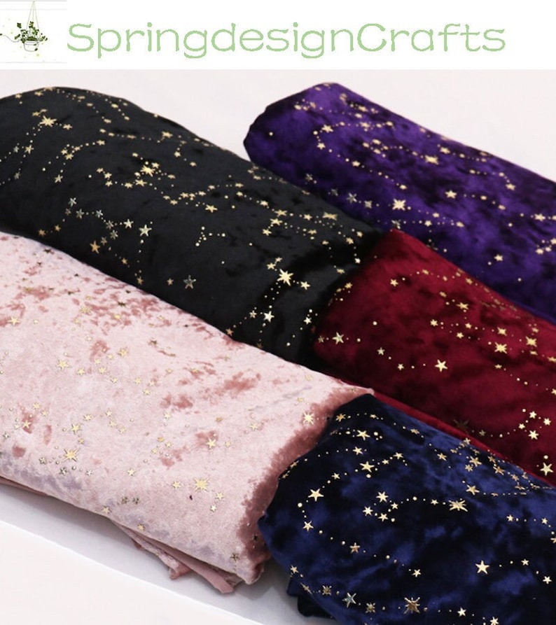 May include: Rolled fabric bolts in various colors, including black, pink, burgundy, navy, and purple. Each fabric features a constellation pattern in gold. The text "SpringdesignCrafts" is visible in the upper left corner.