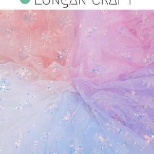 May include: A sheer fabric with a gradient of pink, blue, and white. The fabric is decorated with iridescent sequins in the shape of snowflakes.
