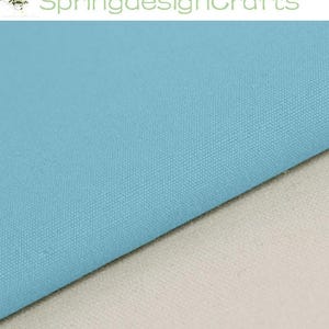 May include: A piece of solid light blue fabric with a visible woven texture layered over a piece of solid off-white fabric. The text SpringdesignCrafts is visible at the top of the image, accompanied by a small graphic of a potted plant.