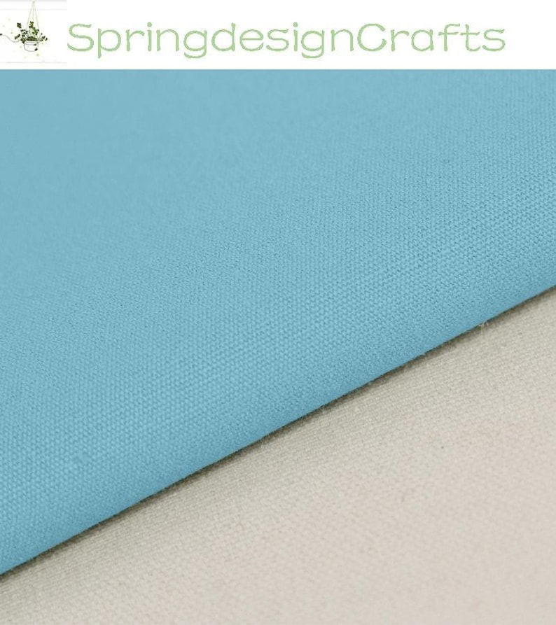 May include: A piece of solid light blue fabric with a visible woven texture layered over a piece of solid off-white fabric. The text SpringdesignCrafts is visible at the top of the image, accompanied by a small graphic of a potted plant.