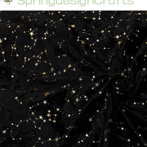 May include: Black velvet fabric with a constellation pattern in gold. The stars are connected by dotted lines, creating a celestial design. The fabric is soft and has a luxurious appearance.