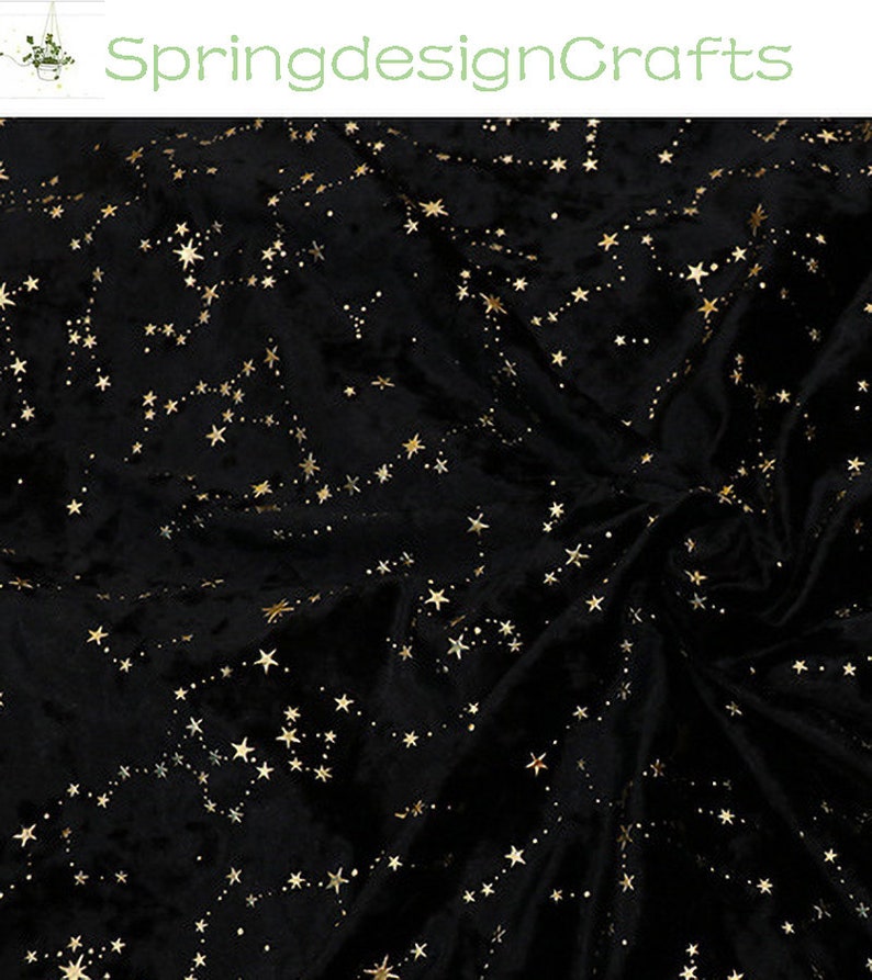 May include: Black velvet fabric with a constellation pattern in gold. The stars are connected by dotted lines, creating a celestial design. The fabric is soft and has a luxurious appearance.
