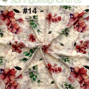 Peut inclure: Tissu floral avec un effet aquarelle. Le tissu pr&eacute;sente de grandes fleurs rouges et roses avec des feuilles vertes et le num&eacute;ro 14. Le fond est de couleur cr&egrave;me claire et textur&eacute;e.