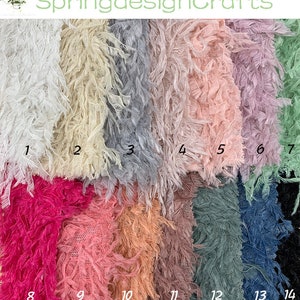 May include: A collection of 14 different colors of feather trim fabric. The fabric is a soft, delicate material with a fringe edge. The colors include white, cream, gray, pink, lavender, green, blue, black, fuchsia, peach, brown, teal, denim, and black.